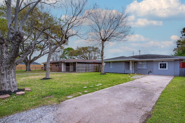 2821 1st Ave N, Texas City, TX 77590 - view of front of house featuring brick siding, driveway, fence, and a front lawn