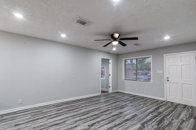 2821 1st Ave N, Texas City, TX 77590 - spare room featuring a textured ceiling, visible vents, baseboards, ceiling fan, and dark wood finished floors
