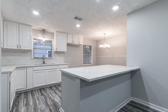 2821 1st Ave N, Texas City, TX 77590 - kitchen with white cabinetry, a sink, dark wood-style floors, and visible vents