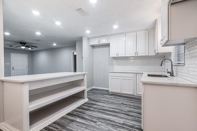 2821 1st Ave N, Texas City, TX 77590 - kitchen with dark wood finished floors, backsplash, a sink, visible vents, and white cabinets
