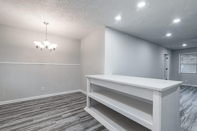 2821 1st Ave N, Texas City, TX 77590 - interior space featuring a textured ceiling, dark wood-style floors, baseboards, recessed lighting, and an inviting chandelier