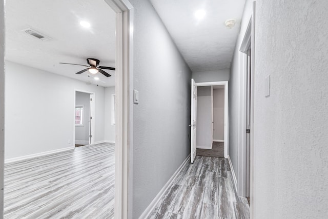 2821 1st Ave N, Texas City, TX 77590 - hall with baseboards, visible vents, wood finished floors, and a textured wall