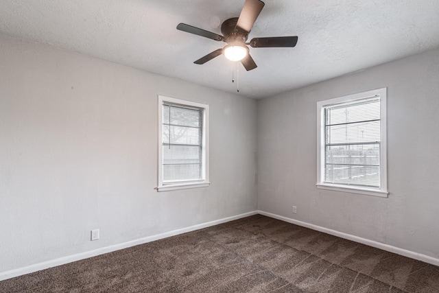 2821 1st Ave N, Texas City, TX 77590 - empty room with plenty of natural light, a textured ceiling, dark carpet, and ceiling fan