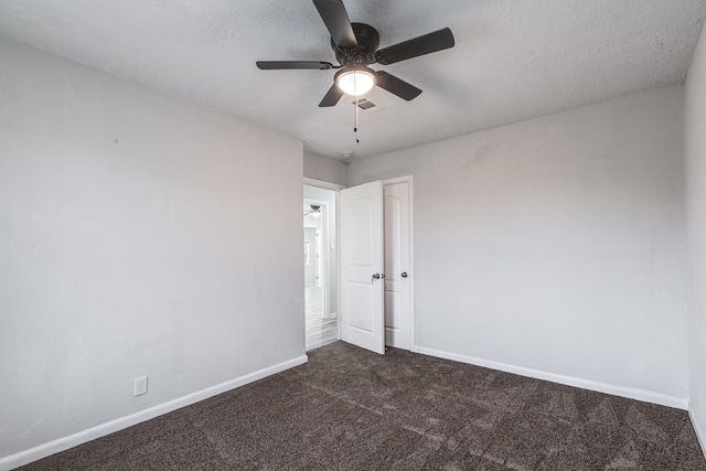2821 1st Ave N, Texas City, TX 77590 - unfurnished room with dark colored carpet, baseboards, a textured ceiling, ceiling fan, and visible vents