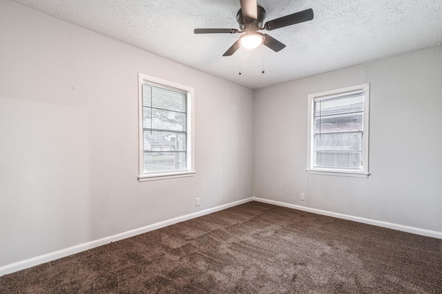 2821 1st Ave N, Texas City, TX 77590 - spare room with baseboards, a textured ceiling, plenty of natural light, and dark colored carpet