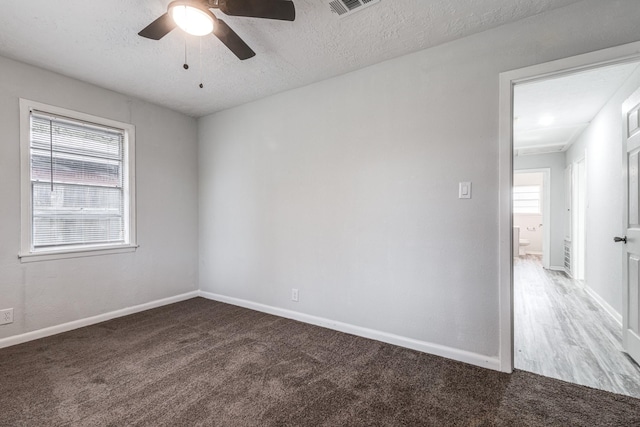 2821 1st Ave N, Texas City, TX 77590 - carpeted spare room with a textured ceiling, ceiling fan, and baseboards