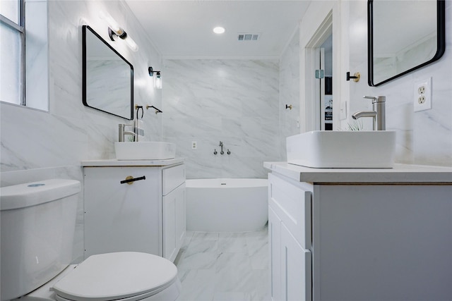 2902 Misty Park Dr, Houston, TX 77082 - bathroom with toilet, marble look tiles, vanity, a bathtub, and tile walls