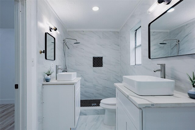 2902 Misty Park Dr, Houston, TX 77082 - bathroom featuring tile walls, toilet, tiled shower, vanity, and marble look tiles