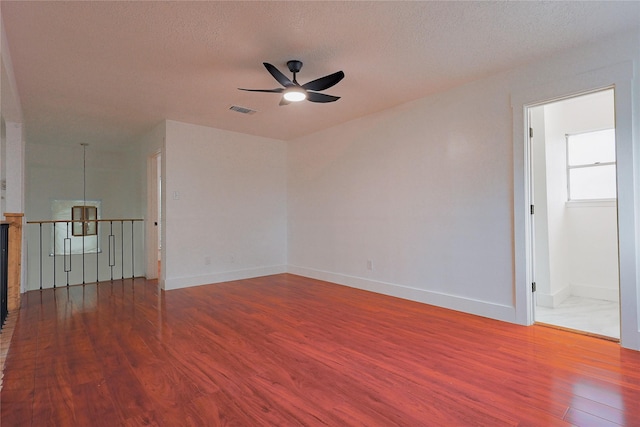 2902 Misty Park Dr, Houston, TX 77082 - unfurnished room featuring a ceiling fan, wood finished floors, baseboards, and a textured ceiling