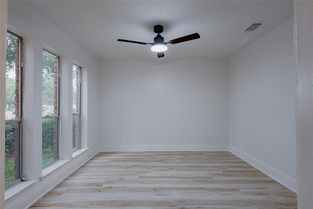 2902 Misty Park Dr, Houston, TX 77082 - spare room featuring healthy amount of natural light, a ceiling fan, light wood-style floors, and baseboards