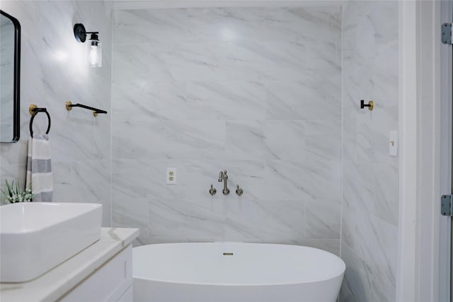 2902 Misty Park Dr, Houston, TX 77082 - bathroom featuring vanity, a freestanding tub, and tile walls