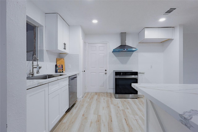 2902 Misty Park Dr, Houston, TX 77082 - kitchen featuring oven, a sink, wall chimney range hood, white cabinetry, and recessed lighting