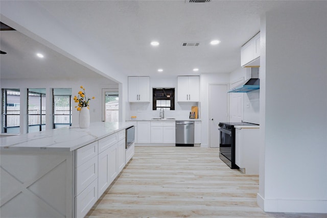 2902 Misty Park Dr, Houston, TX 77082 - kitchen featuring stainless steel dishwasher, black / electric stove, a sink, light wood-style floors, and white cabinets