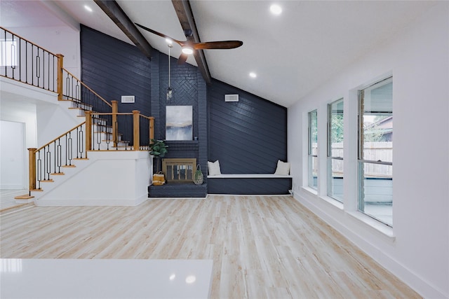 2902 Misty Park Dr, Houston, TX 77082 - unfurnished living room featuring a ceiling fan, wood finished floors, stairway, beamed ceiling, and a brick fireplace