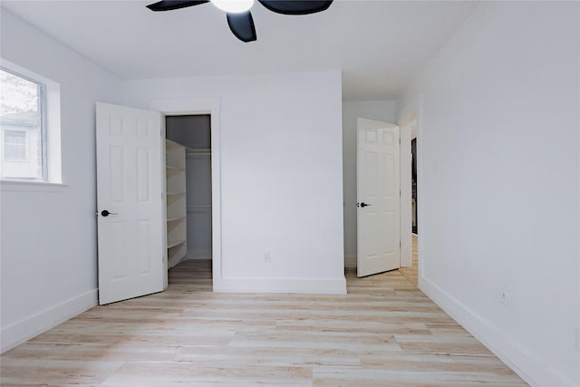 2902 Misty Park Dr, Houston, TX 77082 - unfurnished bedroom featuring wood finished floors, baseboards, a walk in closet, a ceiling fan, and a closet