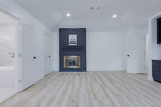 2902 Misty Park Dr, Houston, TX 77082 - unfurnished living room featuring a brick fireplace, lofted ceiling, wood finished floors, and recessed lighting