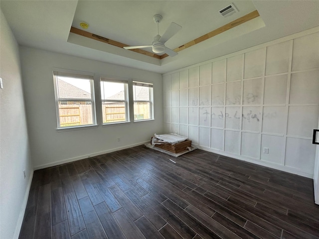 6215 Amberwood Dr, League City, TX 77573 - spare room with a raised ceiling, a ceiling fan, and dark wood-style flooring