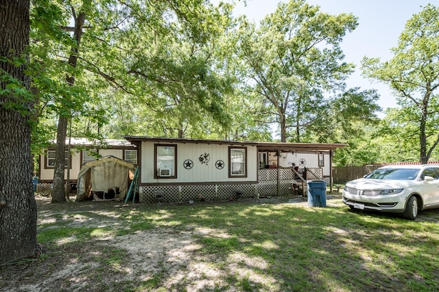 25528 Ipes Rd, Splendora, TX 77372 - manufactured / mobile home with a front yard and fence