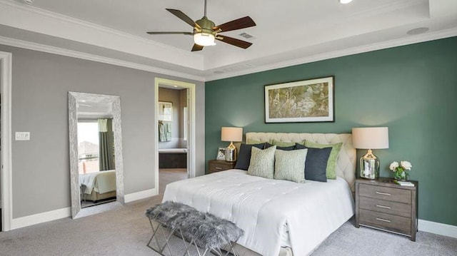1536 River Point Dr, Friendswood, TX 77546 - carpeted bedroom with a tray ceiling, baseboards, connected bathroom, ornamental molding, and a ceiling fan
