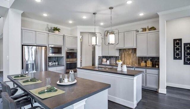 1536 River Point Dr, Friendswood, TX 77546 - kitchen featuring a center island with sink, appliances with stainless steel finishes, dark countertops, recessed lighting, and dark wood-style floors