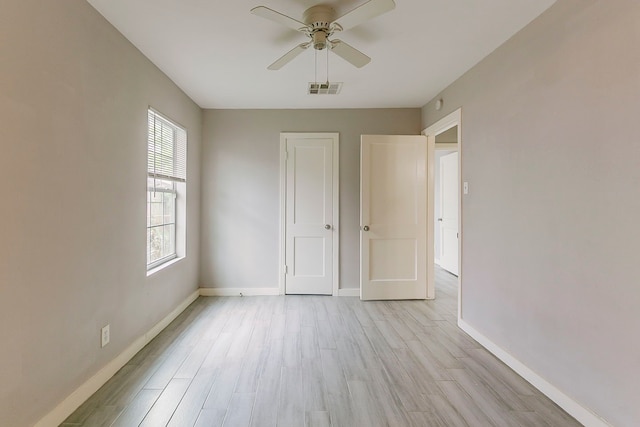 5009 Bataan Rd, Houston, TX 77033 - unfurnished bedroom with baseboards, visible vents, light wood-type flooring, and a ceiling fan