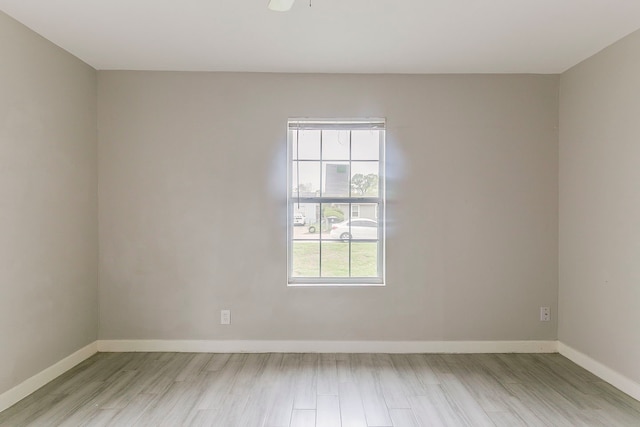 5009 Bataan Rd, Houston, TX 77033 - spare room with a ceiling fan, light wood-style flooring, and baseboards