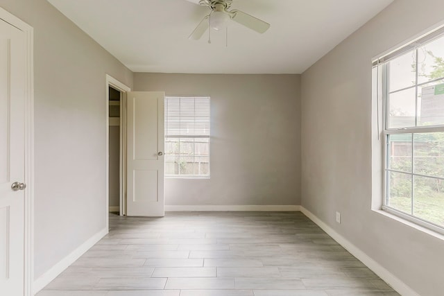 5009 Bataan Rd, Houston, TX 77033 - unfurnished bedroom with baseboards, light wood-style flooring, and a ceiling fan