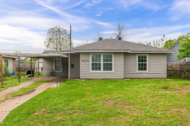 5009 Bataan Rd, Houston, TX 77033 - view of front facade featuring an attached carport, fence, and a front lawn