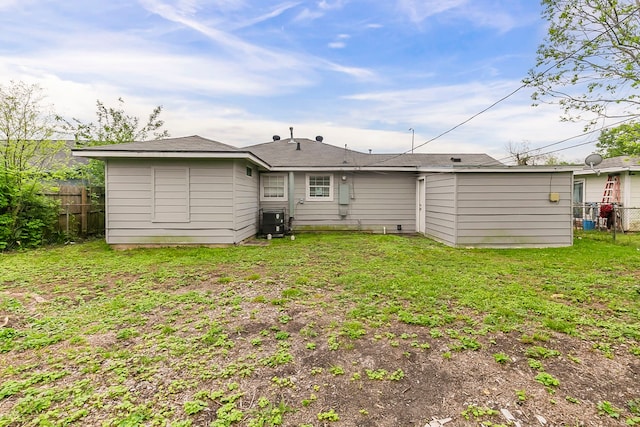 5009 Bataan Rd, Houston, TX 77033 - back of property featuring central air condition unit, a lawn, and fence