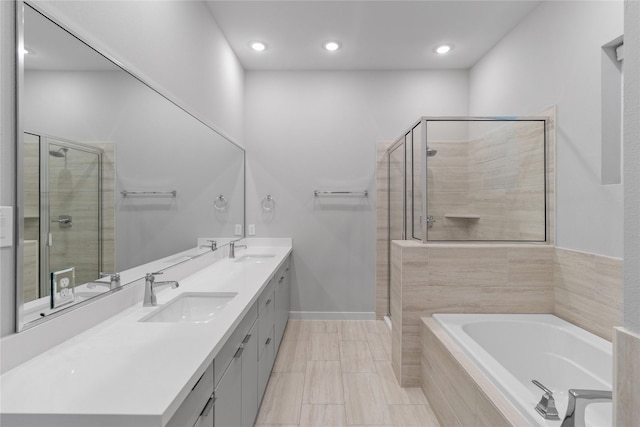 full bath with a bath, a stall shower, and a sink