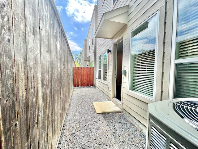 view of property exterior featuring fence and cooling unit
