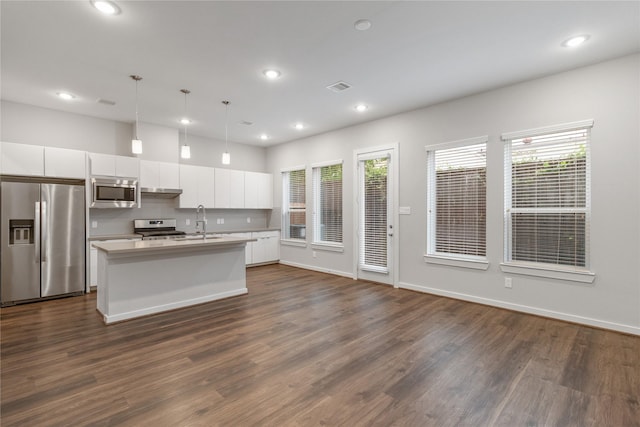 602 Thornton Rd Unit D, Houston, TX 77018 - kitchen with stainless steel appliances, dark wood finished floors, white cabinets, an island with sink, and recessed lighting