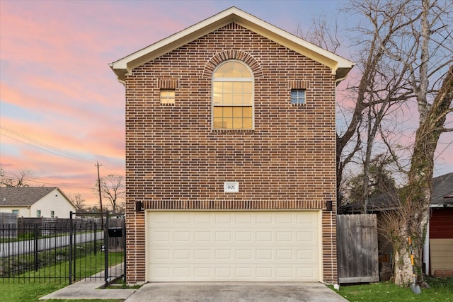 view of front of property featuring fence, driveway, brick siding, and a garage
