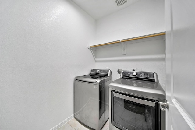 29026 Zacate Creek Ln, Fulshear, TX 77441 - laundry room with washing machine and clothes dryer, light tile patterned floors, and baseboards