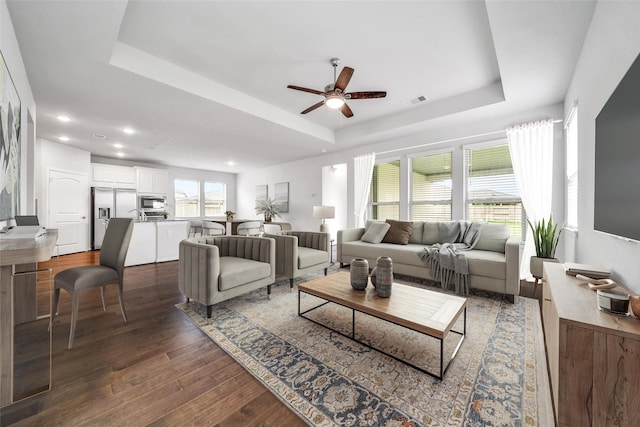 29026 Zacate Creek Ln, Fulshear, TX 77441 - living area featuring a tray ceiling, a ceiling fan, dark wood-style floors, and recessed lighting