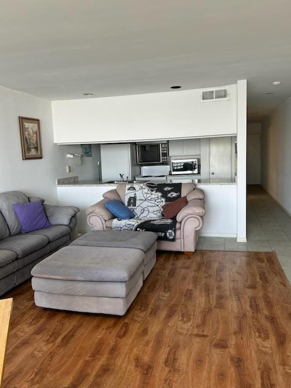 12600 Melville Dr Unit 214A, Montgomery, TX 77356 - living area featuring visible vents and wood finished floors