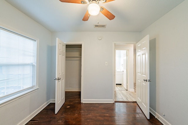 unfurnished bedroom with baseboards, visible vents, and wood finished floors