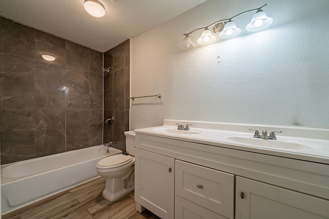 bathroom with a sink, toilet, shower / bathtub combination, and wood finished floors