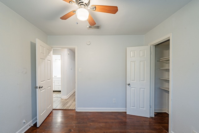 unfurnished bedroom featuring a closet, a ceiling fan, wood-type flooring, baseboards, and visible vents