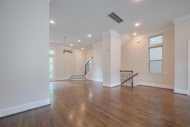 spare room featuring visible vents, crown molding, baseboards, recessed lighting, and dark wood finished floors