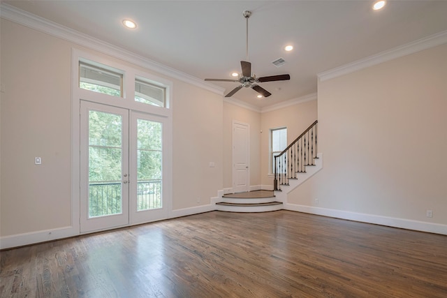 interior space featuring crown molding, visible vents, a healthy amount of sunlight, and dark wood-type flooring