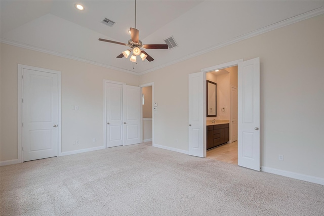 unfurnished bedroom with light colored carpet, ornamental molding, baseboards, and visible vents