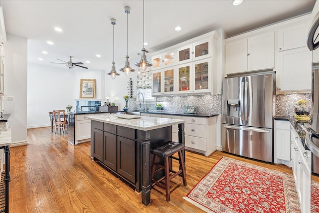 1101 Heights Blvd, Houston, TX 77008 - kitchen featuring stainless steel refrigerator with ice dispenser, recessed lighting, white cabinetry, and decorative backsplash