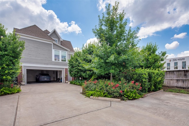 1101 Heights Blvd, Houston, TX 77008 - view of home's exterior with concrete driveway, a garage, roof with shingles, and brick siding