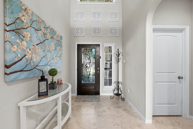7611 Mesquite Hill Ln, Richmond, TX 77469 - entryway featuring arched walkways, baseboards, and light tile patterned floors