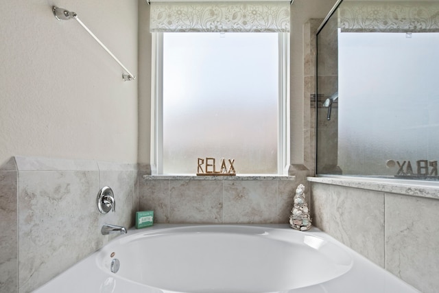 7611 Mesquite Hill Ln, Richmond, TX 77469 - bathroom featuring plenty of natural light and a bath