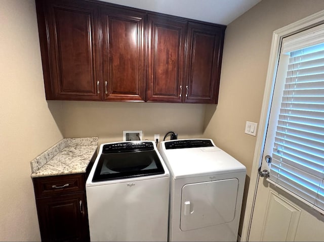laundry area with cabinet space and separate washer and dryer