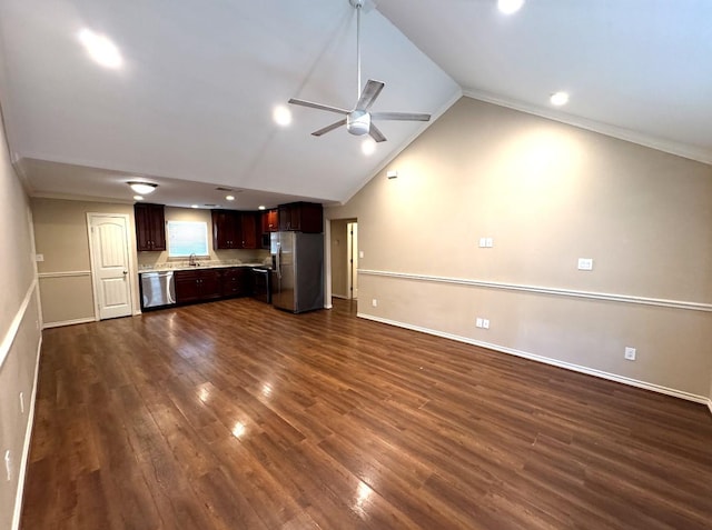unfurnished living room with baseboards, ceiling fan, dark wood-type flooring, a sink, and vaulted ceiling