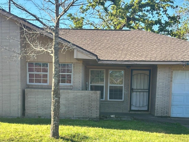 view of front of property with brick siding and a shingled roof