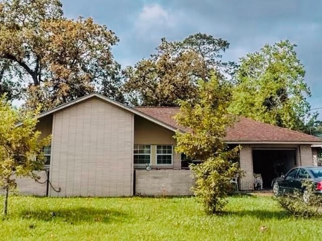 view of home's exterior featuring a lawn and a garage